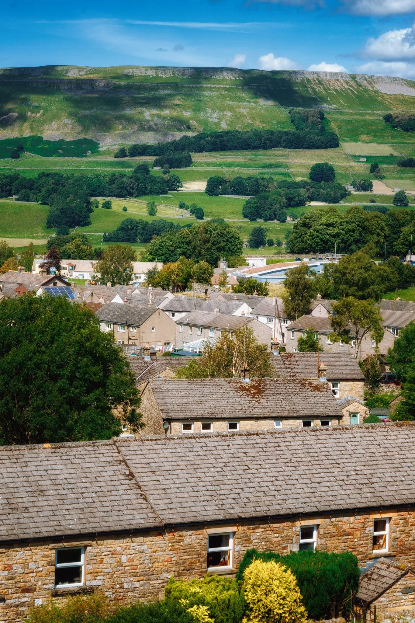 Clambering back out of the gorge and back north across all the farmland (whilst batting off horseflies), a view over Hawes towards Stags Fell presents itself, which I dutifully shoot.