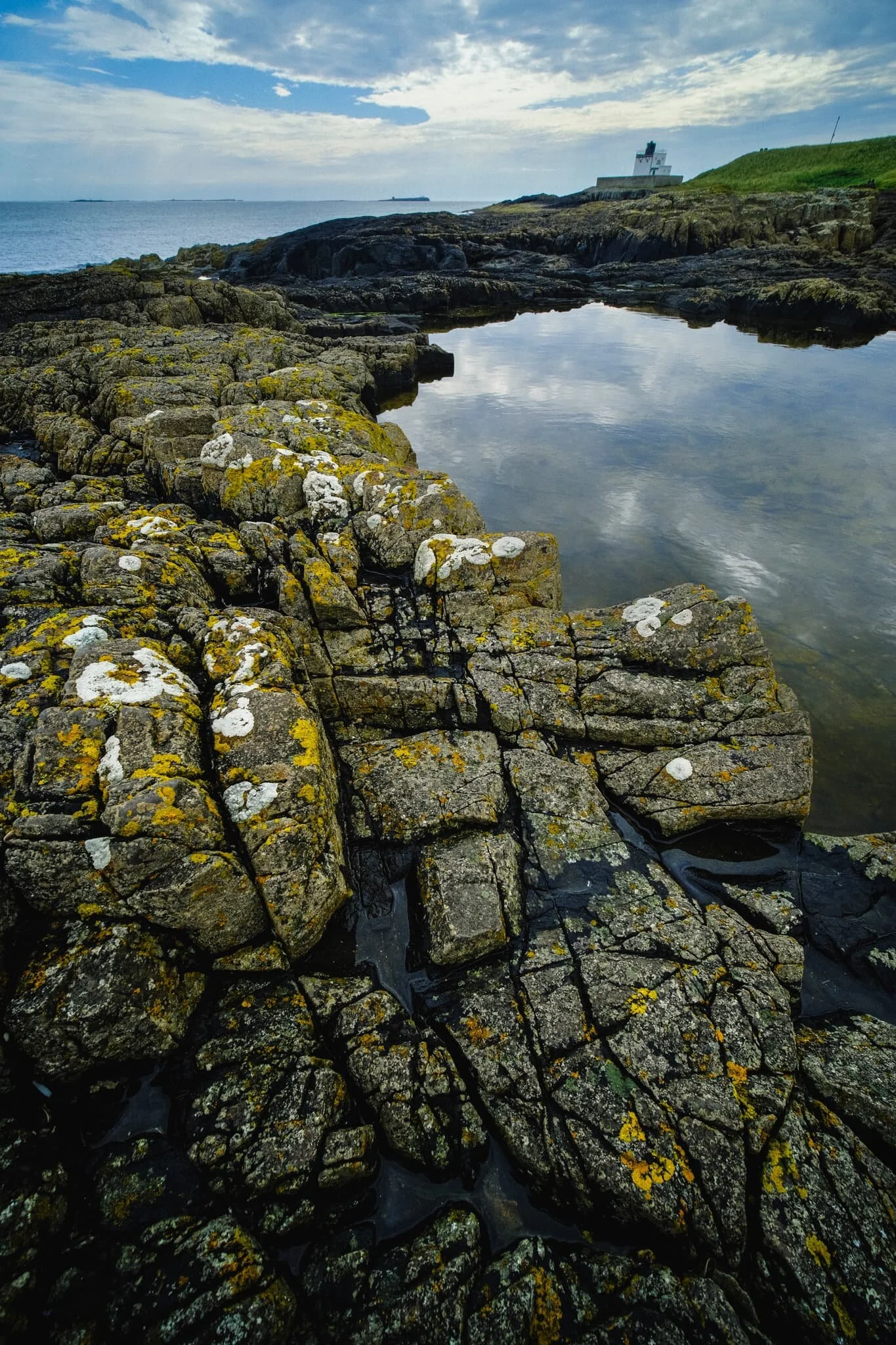 North of Bamburgh Lighthouse, around Blackrocks Point, we found this open rock pool surrounded by these tessellating structures of volcanic rock. Made for a lovely, if challenging, composition.
