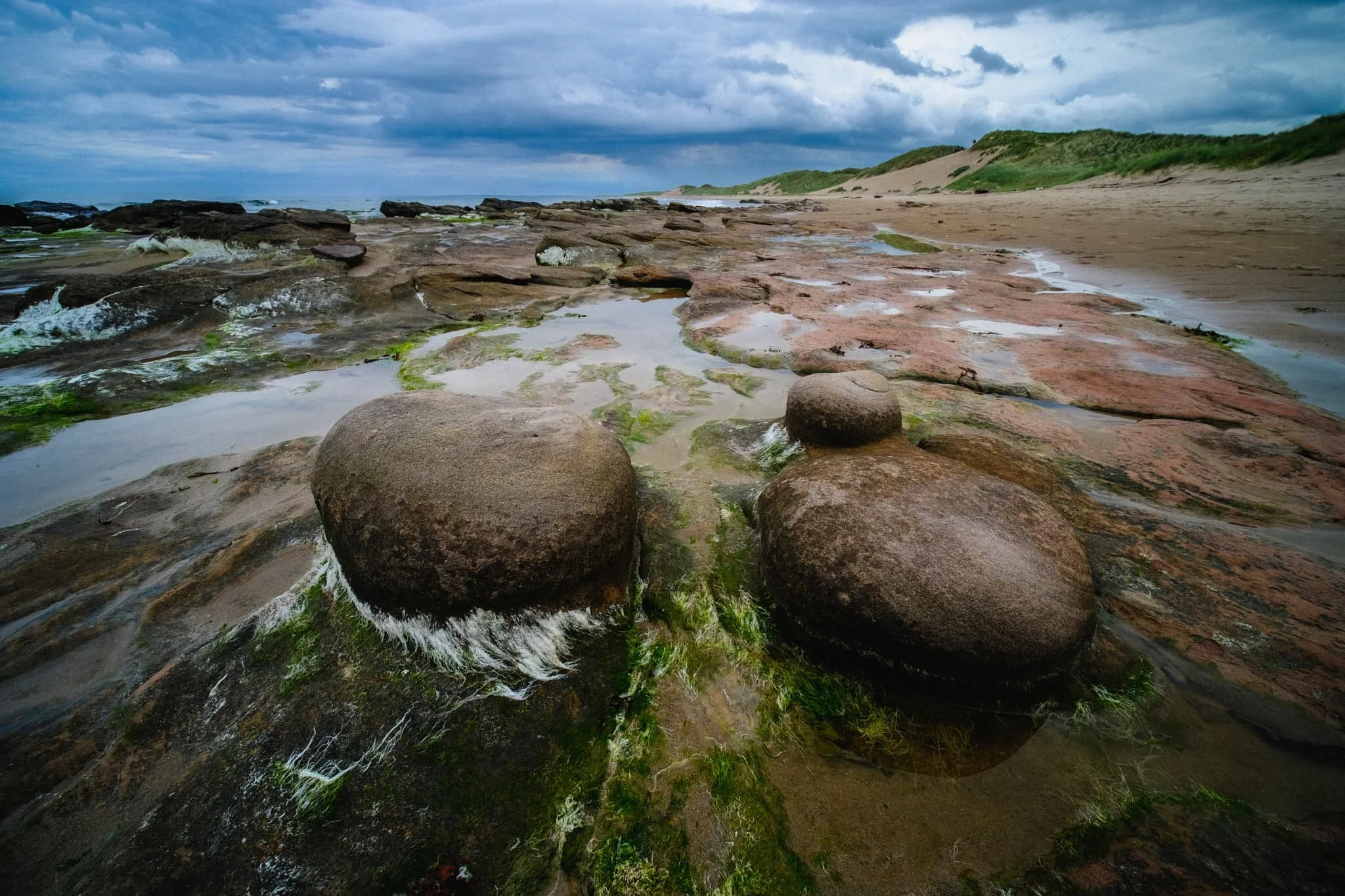 Sculpted rocks, sand dunes, the North Sea, and a stormy sky. Love it.