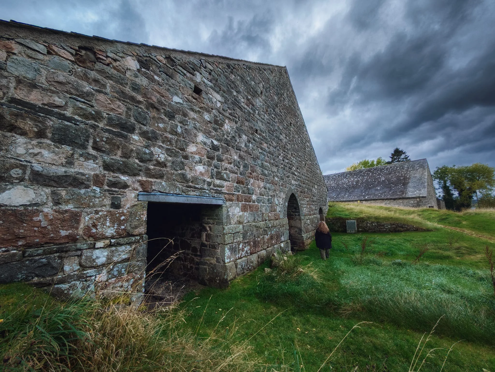The abandoned buildings of Bonawe Iron Furnace. This building was one of two charcoal sheds, built into a bank so that material could be brought in at the back of the building, at the top of the slope, and removed at a lower level at the front.