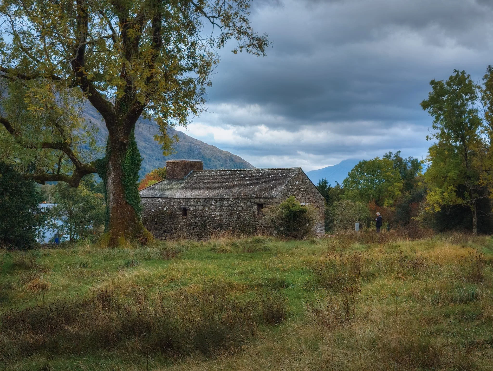 The top of the blast furnace building, surrounded by beautiful Highland autumn foliage on a moody overcast day.