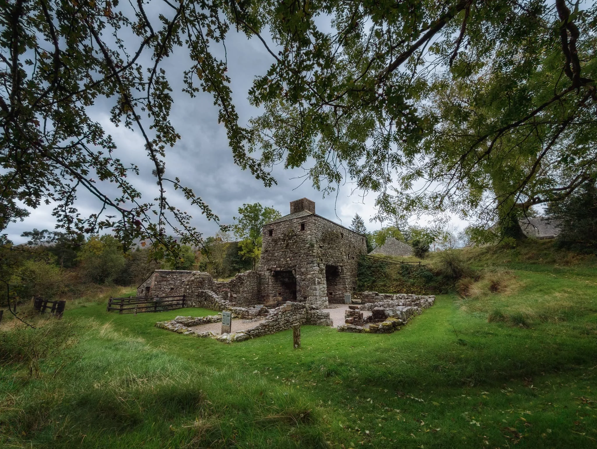 The heart of the Bonawe Iron Furnace site, framed by autumnal foliage.