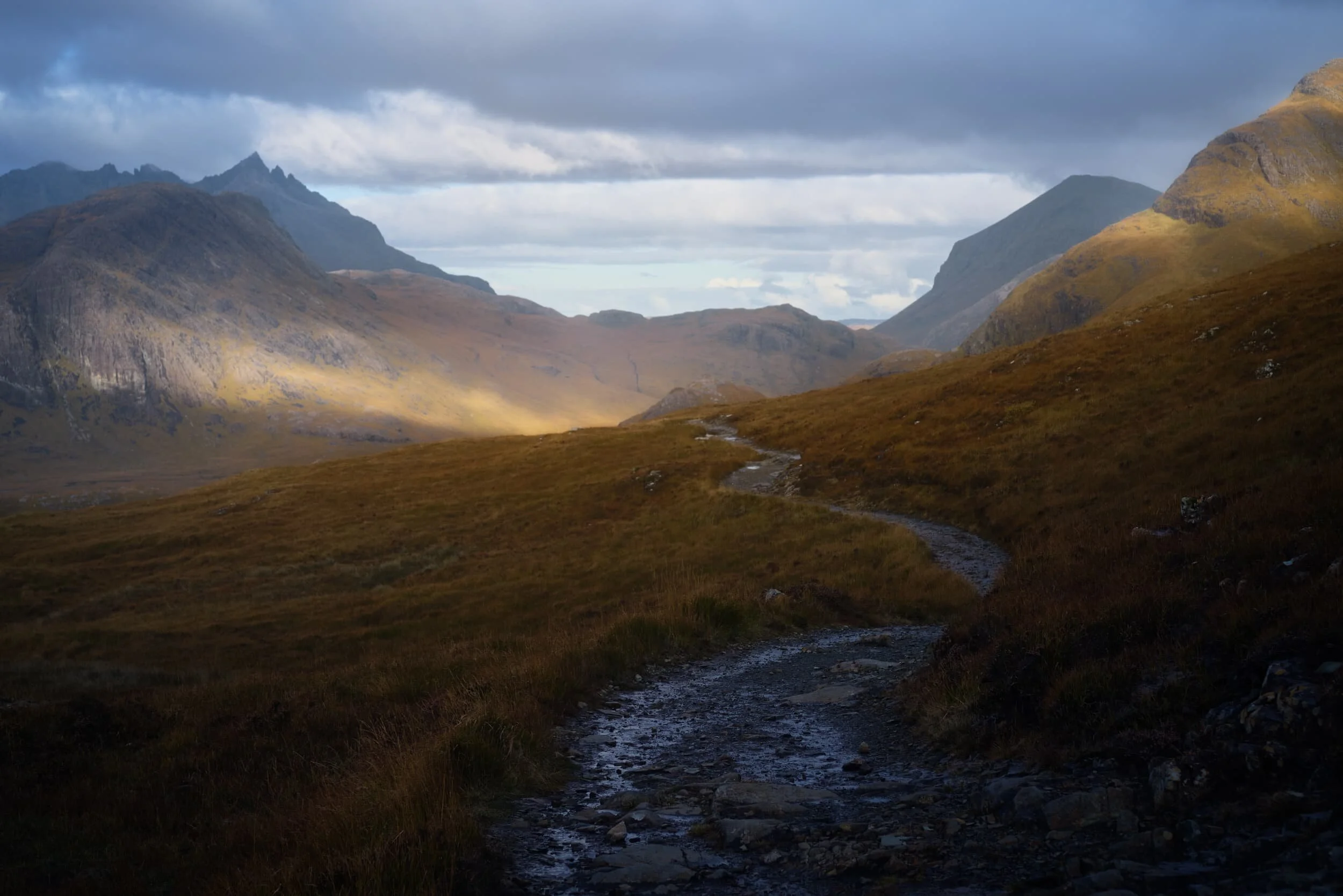 Bright slivers of golden light streak across the various faces of the Black Cuillins. In my head, the Lord Of The Rings theme music plays incessantly.