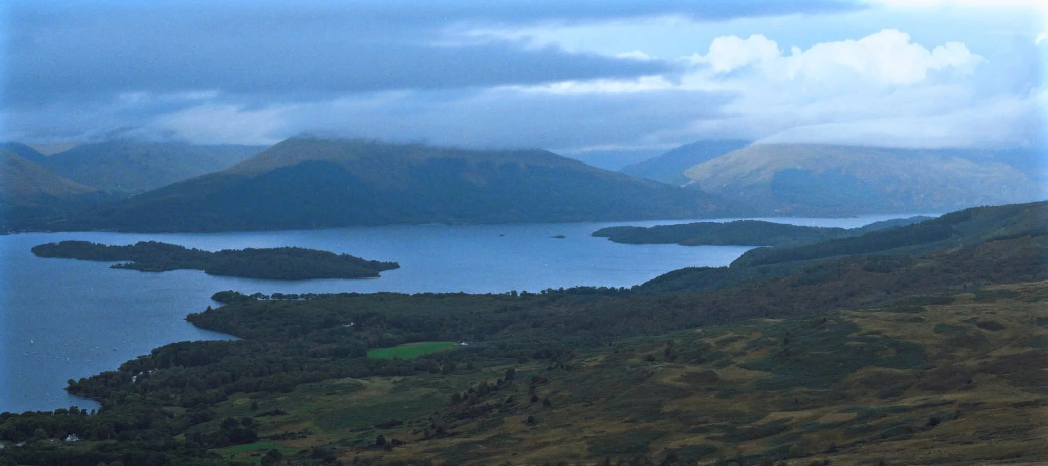 A 5-image panorama, taking in the views from Conic Hill towards the Arrochar Alps, the low clouds clipping their peaks.