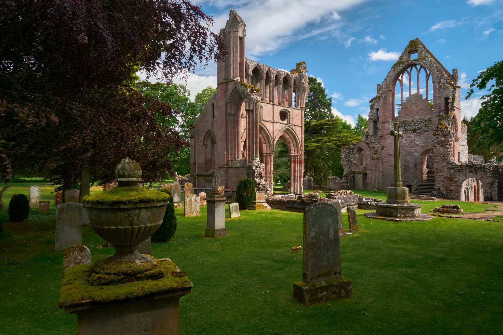 And behold, the ruins of Dryburgh Abbey. It’s red colour comes from being primarily constructed from Devonian sandstone. The tall structure centre is the North Transept, representing the most complete surviving portion of the original abbey church. The structure on the right is the East Range, the remains of the monastic domestic buildings.