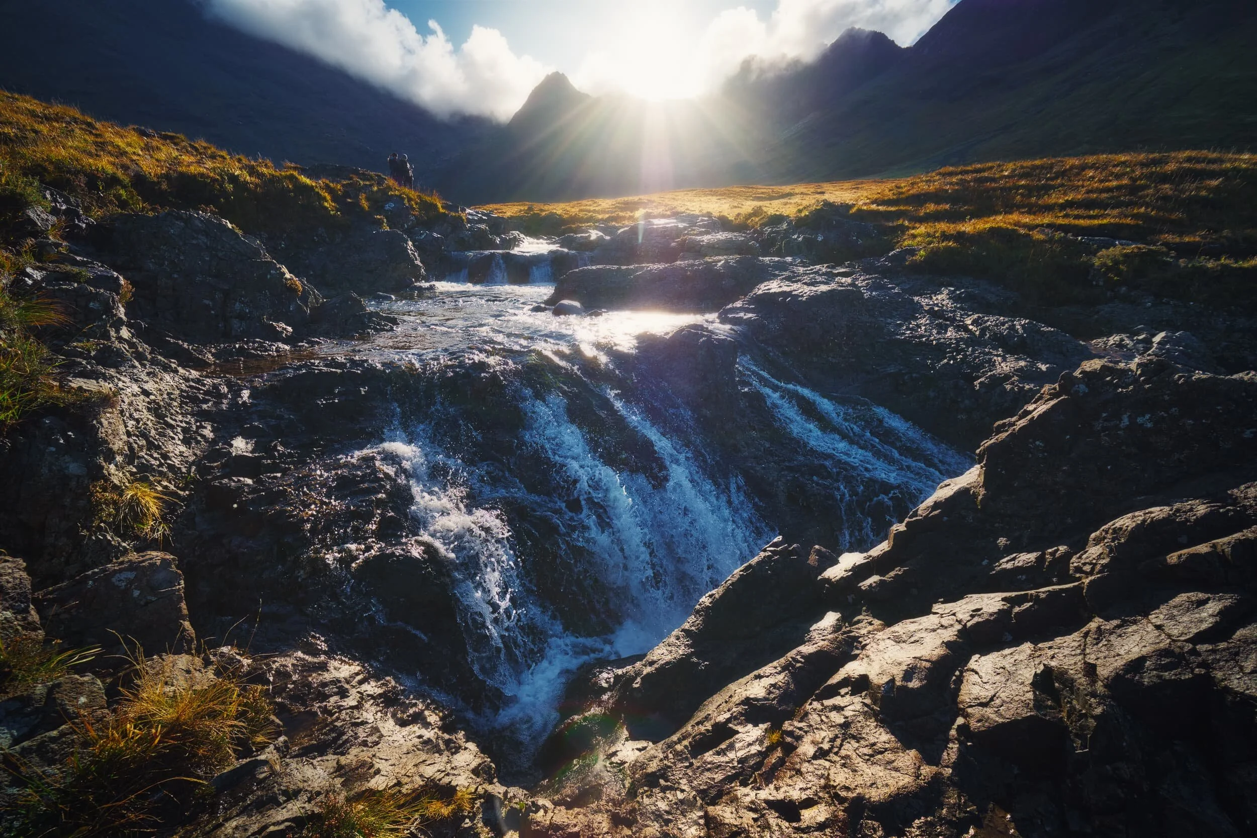 One of the last cascades on the Allt Coir’ a’ Tairneilear before the river flattens out directly underneath Sgùrr an Fheadain . Beautiful golden light picks out the various ridges and shelves of rock around the river.