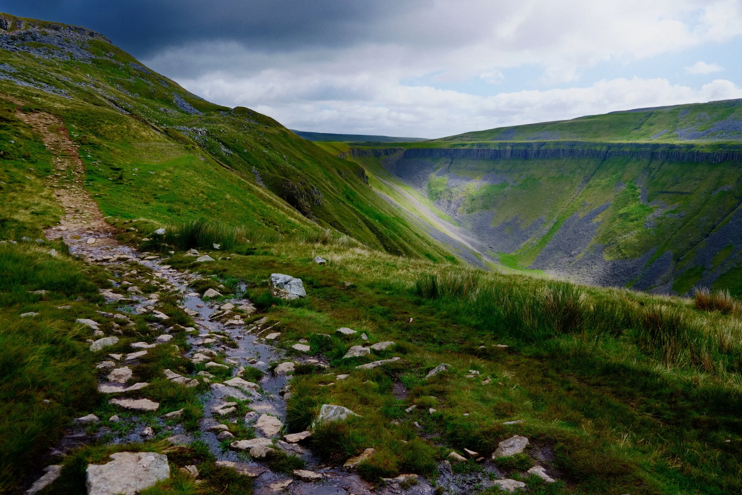The first sign of what’s to come. The path continues up to the left but our gaze is fixated towards the steep valley of High Cup Nick and its rim of cliffs.