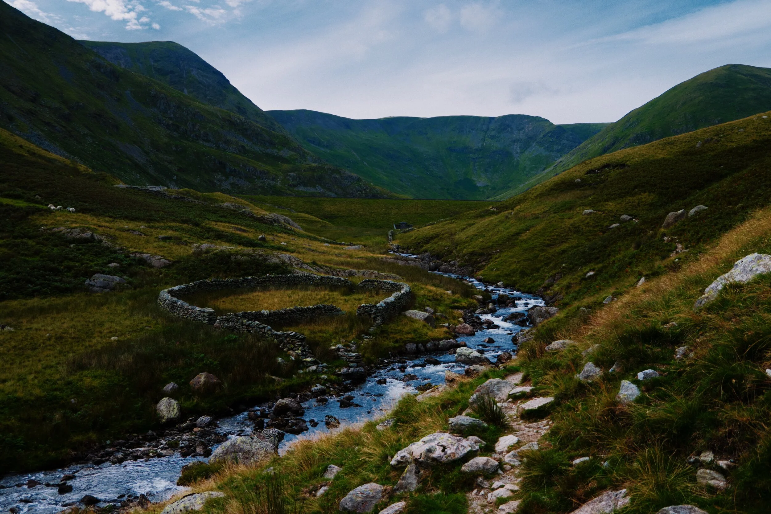 A wet and undulating path at Whether Fold to navigate now as we near the reservoir. The peak on the left is Froswick, the “wall” in the middle is Gavel Crag (the southern face, ultimately, of High Street), and the rightmost peak is Lingmell End.