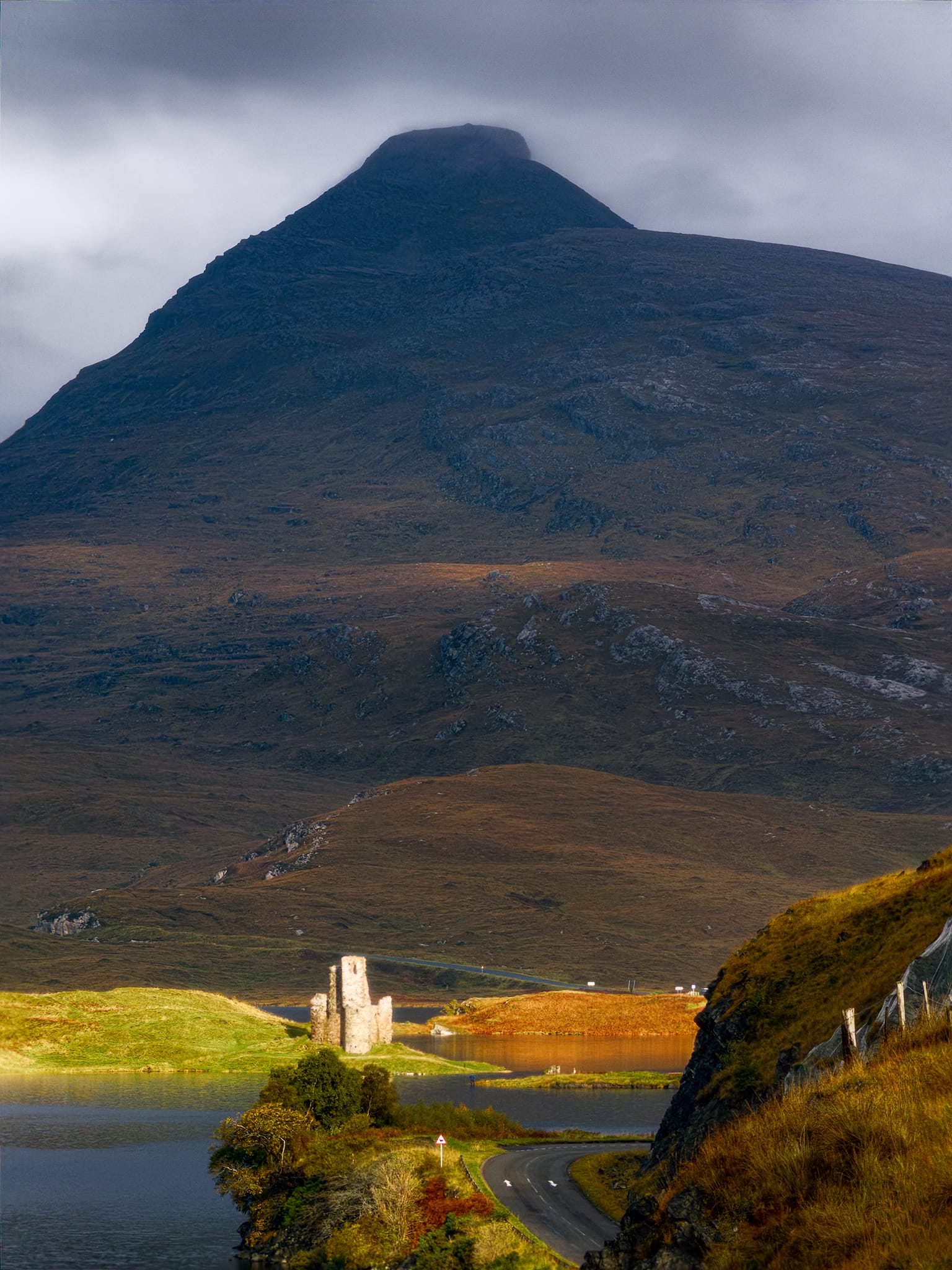 Early in the day, heading to Inverkirkaig, we were blessed with beautiful light conditions. As we crested the road north of Inchnadamph, this frankly ridiculous view of dark Quinag towering over the spotlighted ruins of Ardvreck Castle stopped us in our tracks. We found a handy free parking layby off the road, and began shooting compositions like crazy.