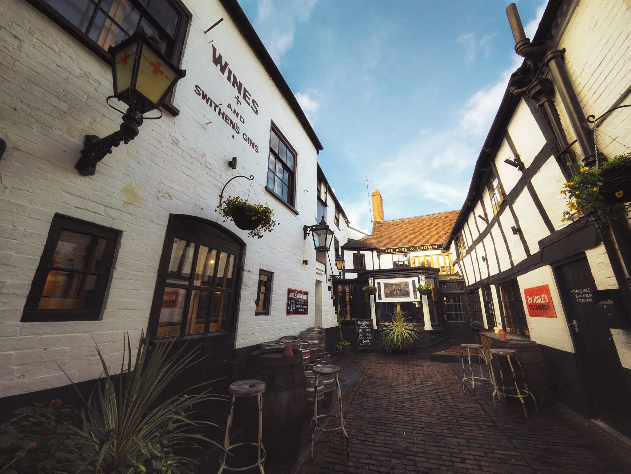 Stashed away down a yard is The Rose & Crown , proclaiming to be one of Ludlow’s oldest pubs, with documents dating back to the 1200s. This courtyard inn as we see it now was built in stages from the 1600s. It still features 1700s brick and timber-frames with sashes and even the rear walls show 1600s timber framing and medieval stone windows. Still in operation as a pub, owned by the Joules Brewery.