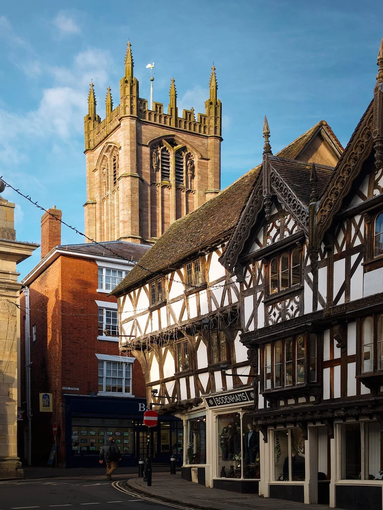 A tighter composition, with low light highlighting the top of Bodenhams , a family run business since 1860 inhabiting a building dating from 1405. Rising peerlessly above, and catching the golden light, is St. Laurence’s Church. Not a bad shot from a phone, right?