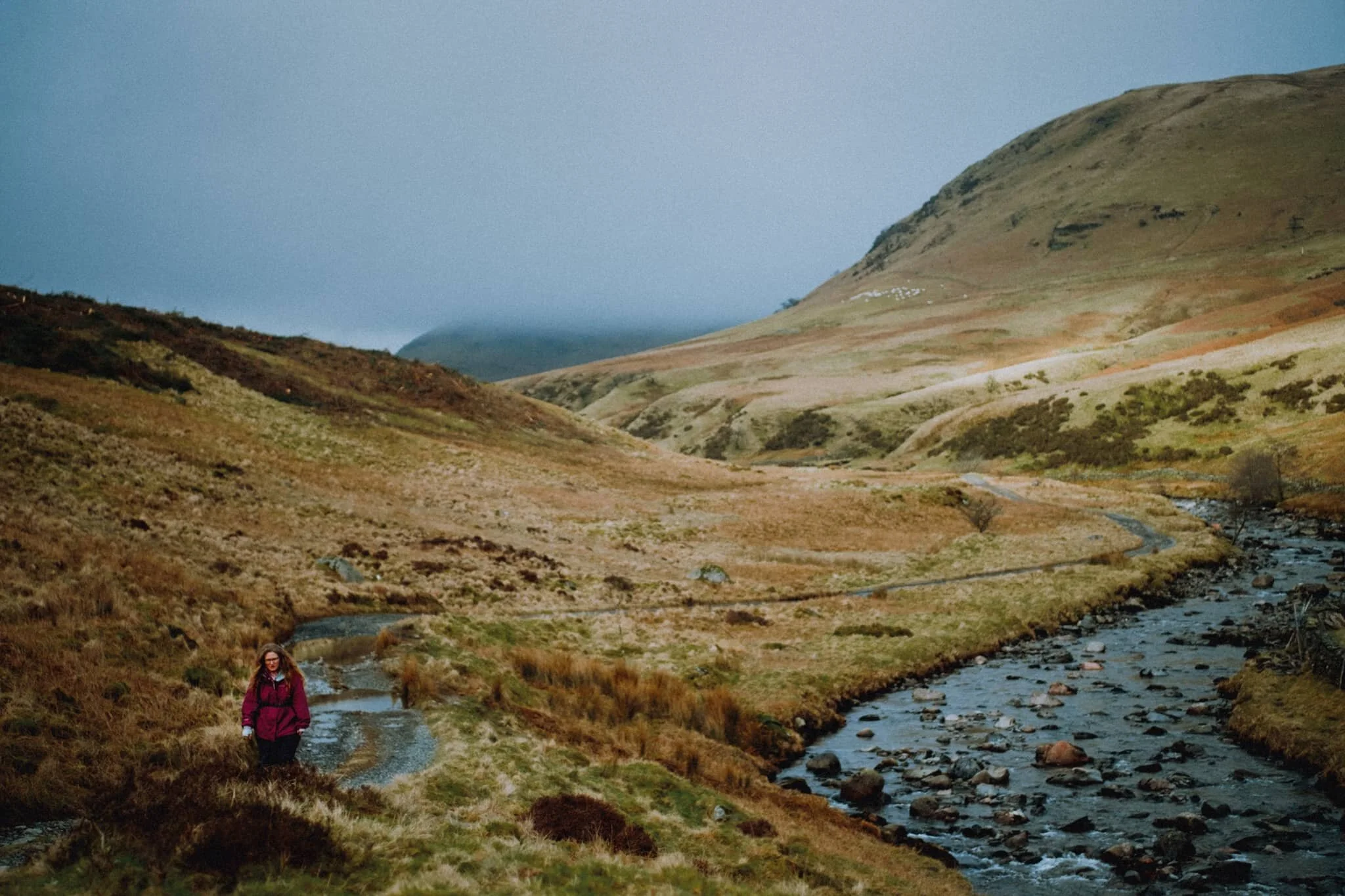 Looking back at Greenside Crag as the sun finally breaches the cloud cover and strikes across the face of the fell.