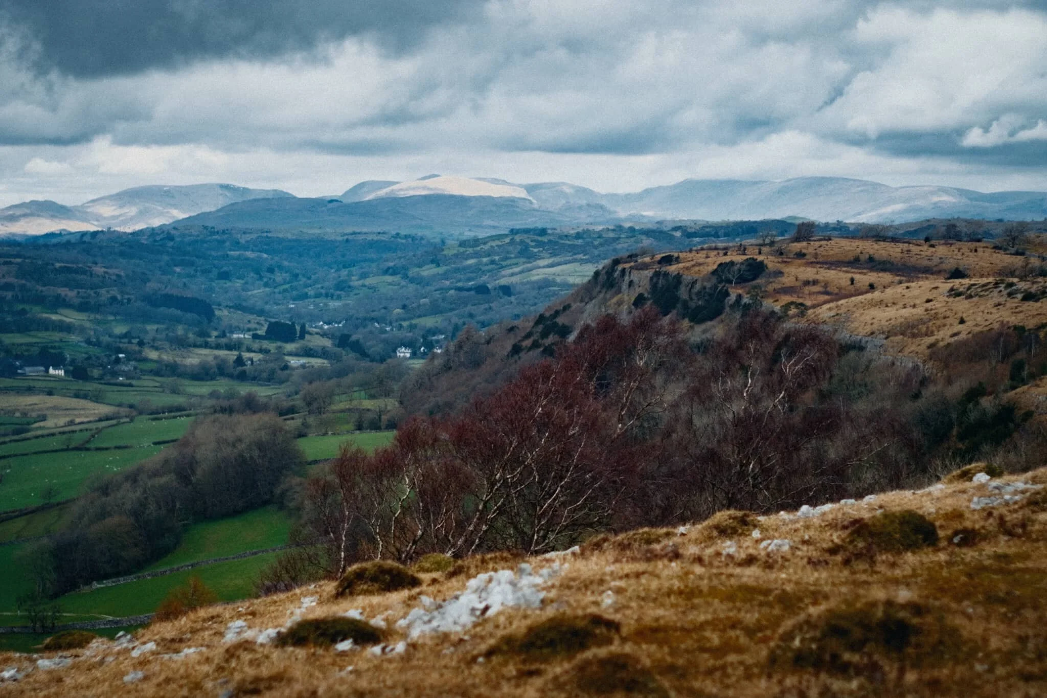 The cliffs north of Whitbarrow Scar with the Eastern Lake District fells in the distance.