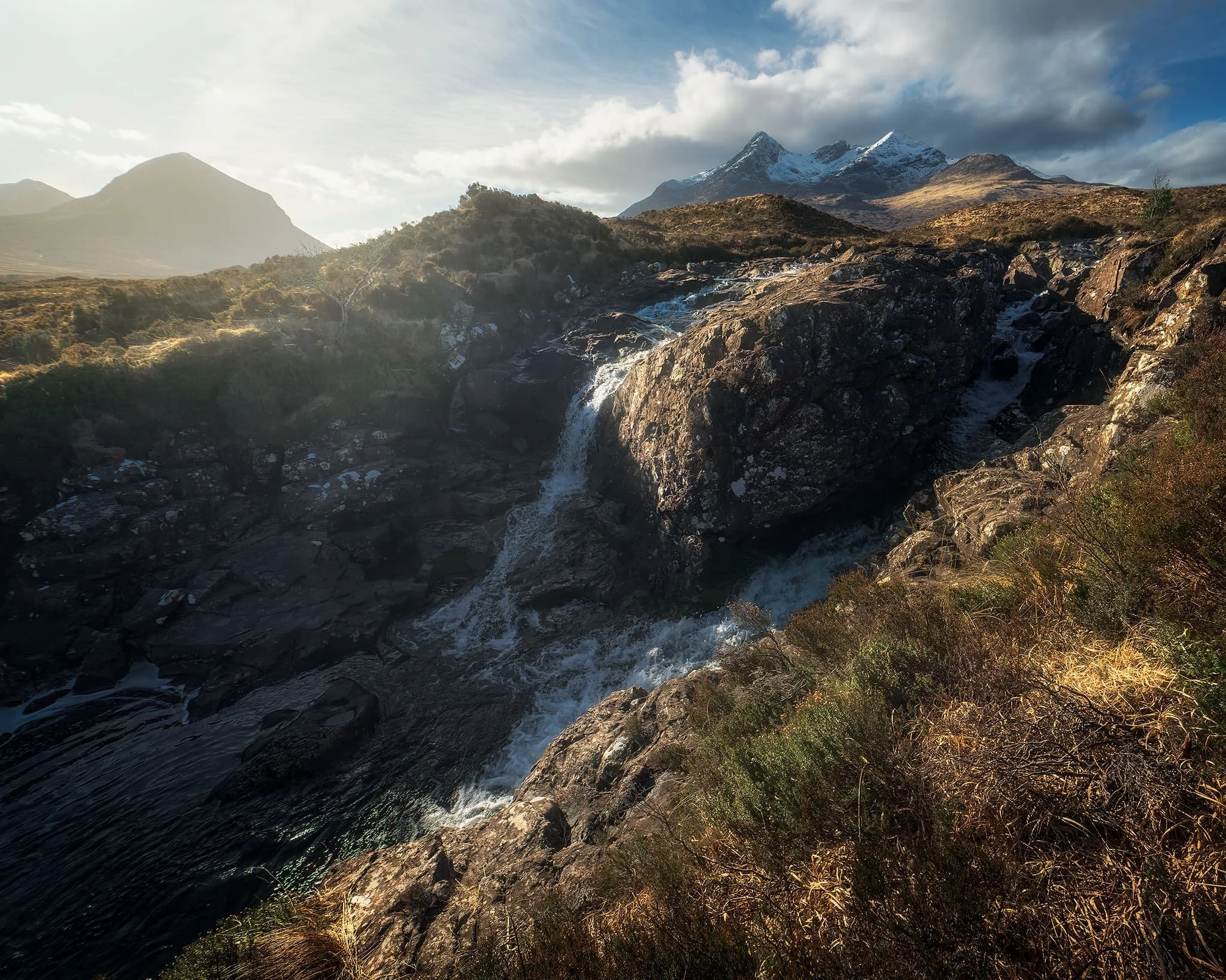 Afterwards, we began the hike up alongside one of Sligachan’s many rivers, this one being the Allt Dearg Mòr (“Great Red River”). Numerous waterfalls can be found along the river, this one being one of the bigger ones. My ultra-wide 14mm lens was able to capture not only the entirety of the falls and the snow-capped Black Cuillins, but some of the Red Cuillins too.