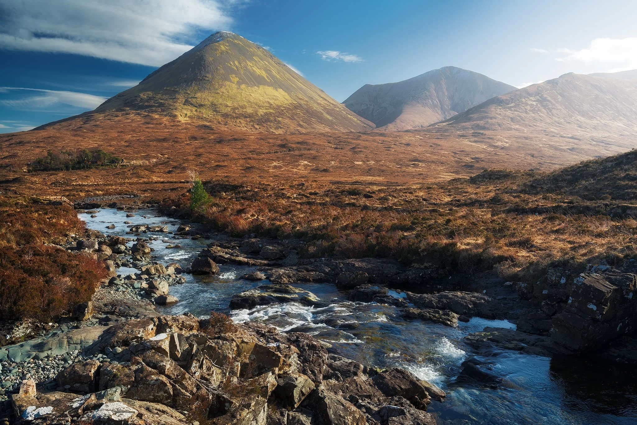 Looking back down the river towards the Red Cuillins saw clearer skies. On the left, the wizard’s hat of a mountain is Glamaig (775 m/2,543 ft), catching the light on its smooth flanks. The other Red Cuillin in the distance is Beinn Dearg Mhòr (731 m/2,398 ft)