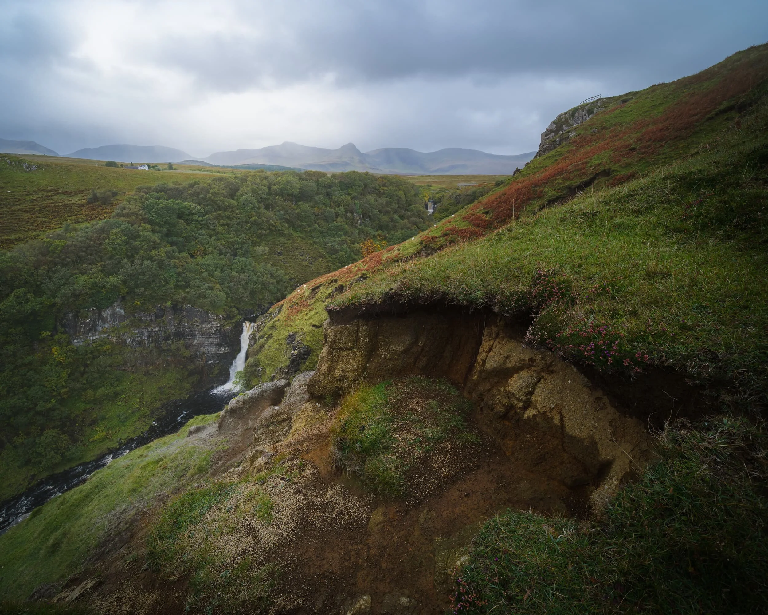 And now a much wider composition, which manages to capture both of the Lealt Falls with the Trotternish landslip and Sgùrr a’ Mhadaidh Ruaidh in the distance. A squall was also closing in on the peaks and started to obscure them.