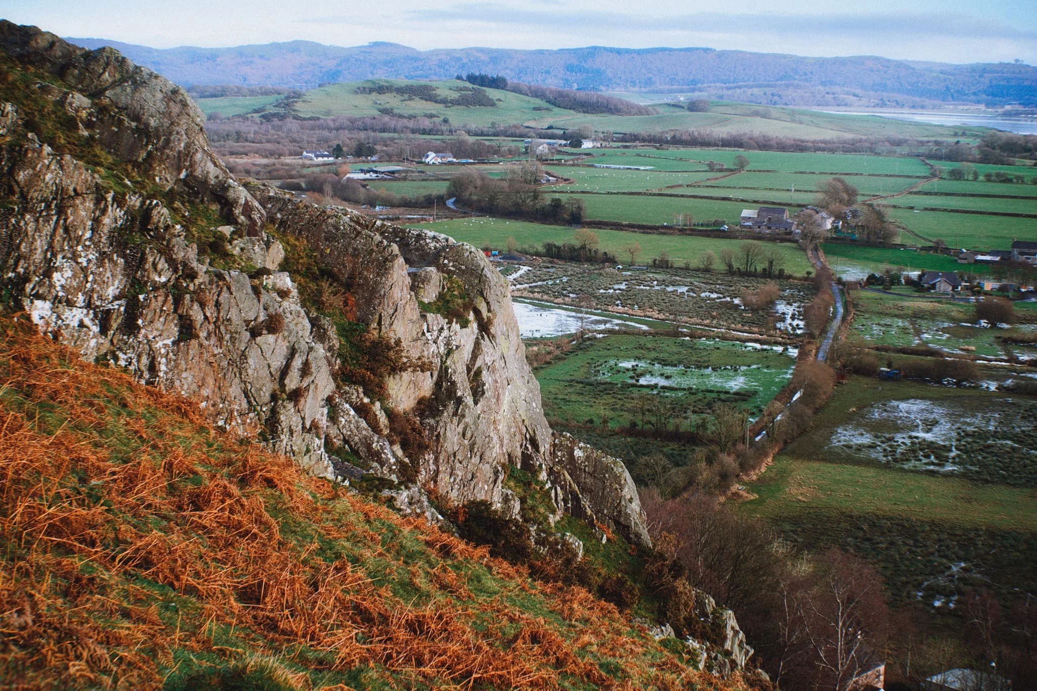 The trail quickly grew steeper, which also provided fantastic views. From the shoulder of Hoad Hill, the wet autumn and December are evident in the flooded fields near the coast of the Leven Estuary.