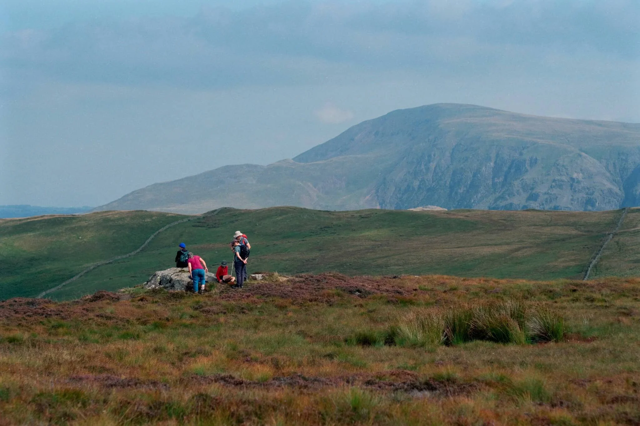Fellow hikers branch off from the path to take in the views towards the Helvellyn range, and Clough Head (726 m/2,382 ft) in particular.