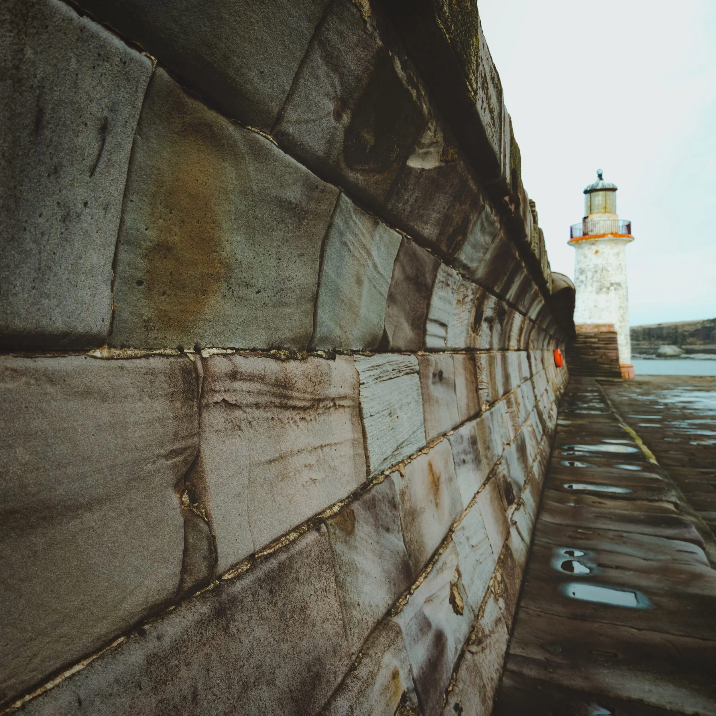 West Pier Lighthouse at Whitehaven. The curved walls of the pier’s breakwaters intrigued me enough to feature them in a wider composition. I think it’s alright.
